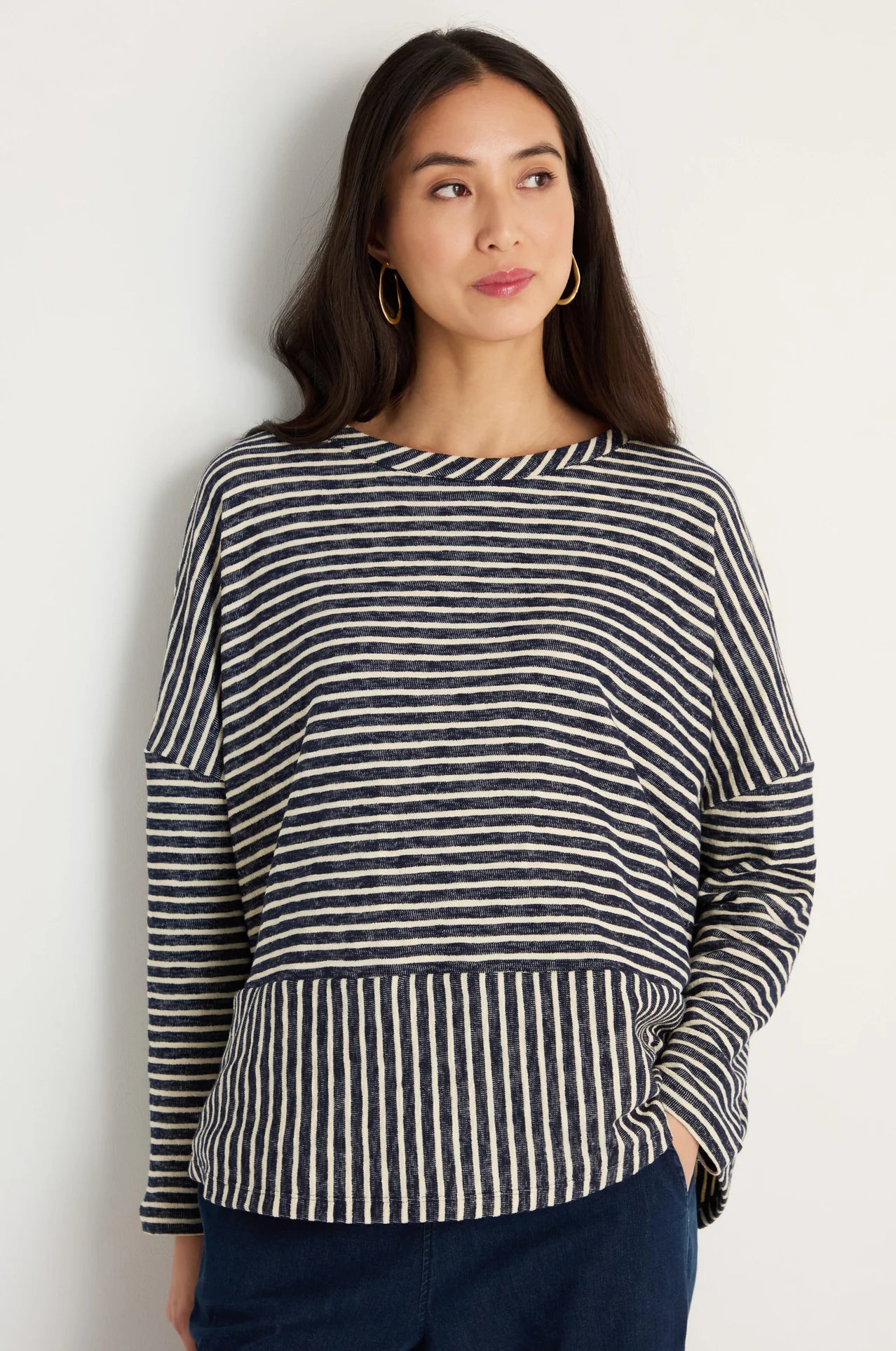 women wearing a striped navy and cream top.