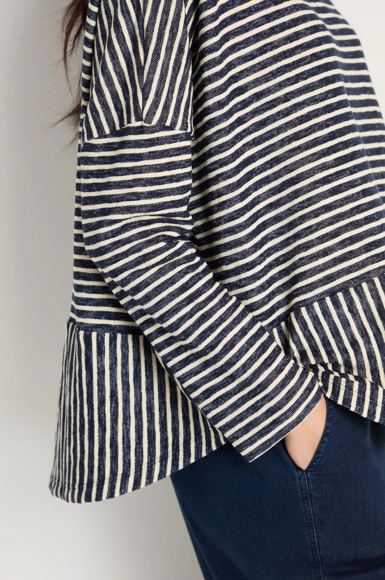 women wearing a striped navy and cream top.