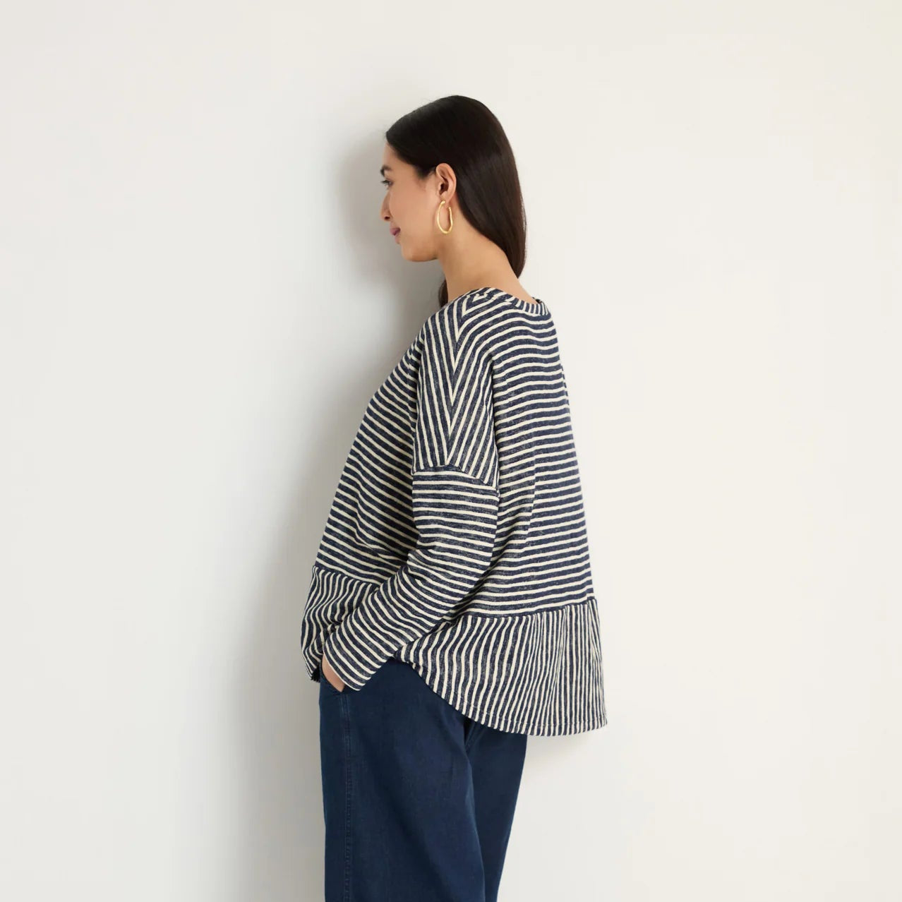 women wearing a striped navy and cream top.