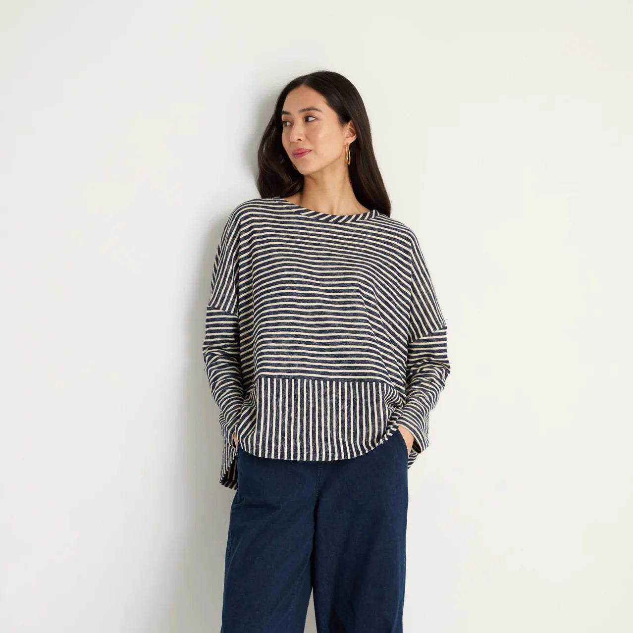 women wearing a striped navy and cream top.