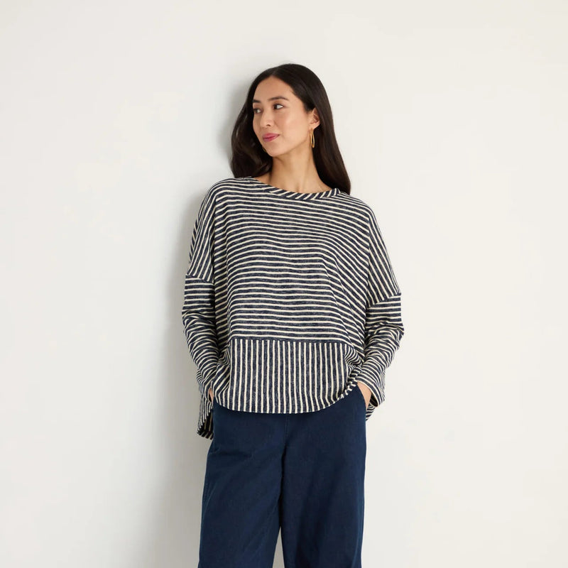 women wearing a striped navy and cream top.