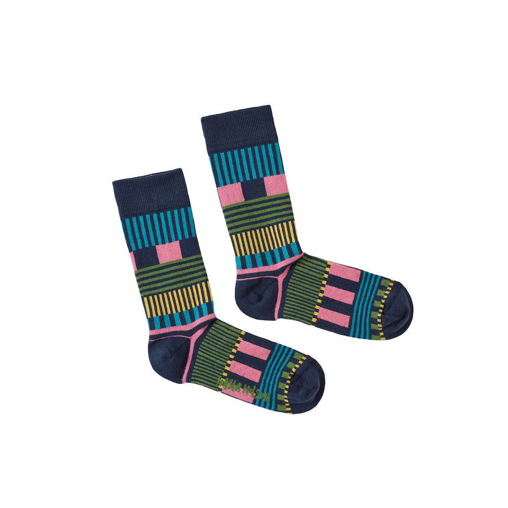 Colorful patterned socks by Donna Wilson, featuring navy, green, pink, and yellow stripes.