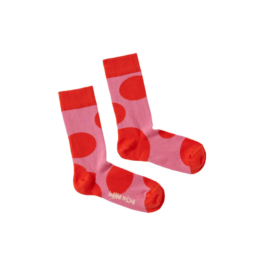 Pink socks with red polka dots and matching red cuffs, by Donna Wilson. Fun and bright design.