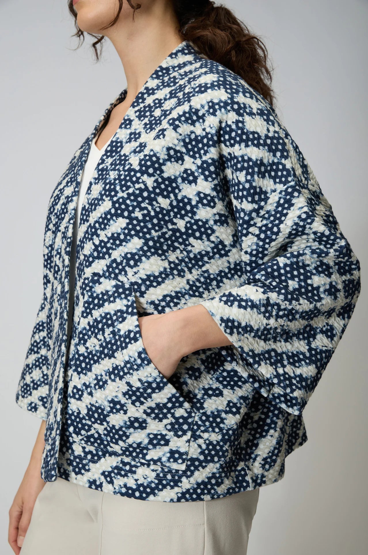 Women wearing a navy and white diamond shaped tie dye jersey open front jacket. 