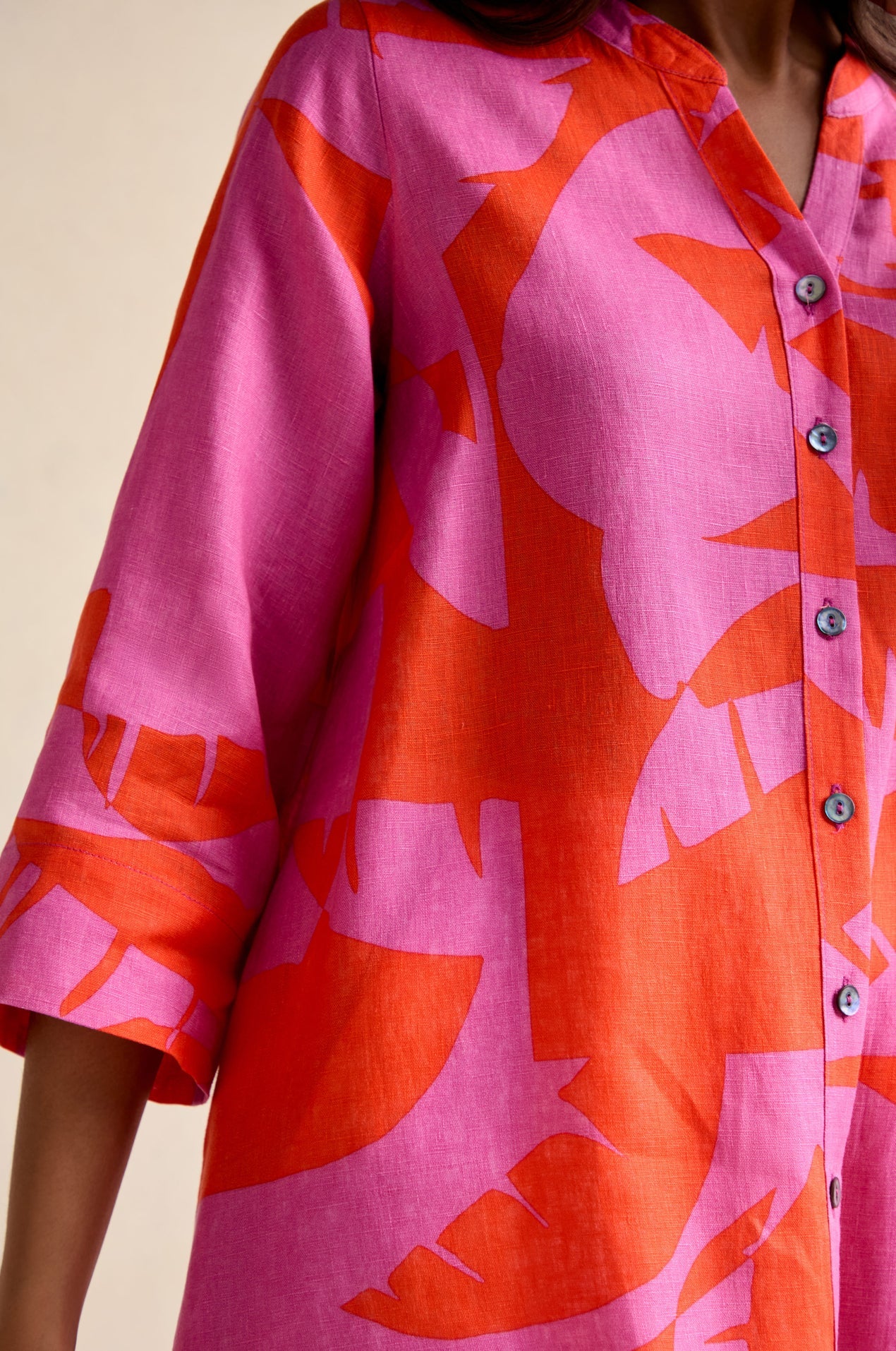 Close-up of a pink and orange floral patterned shirt.