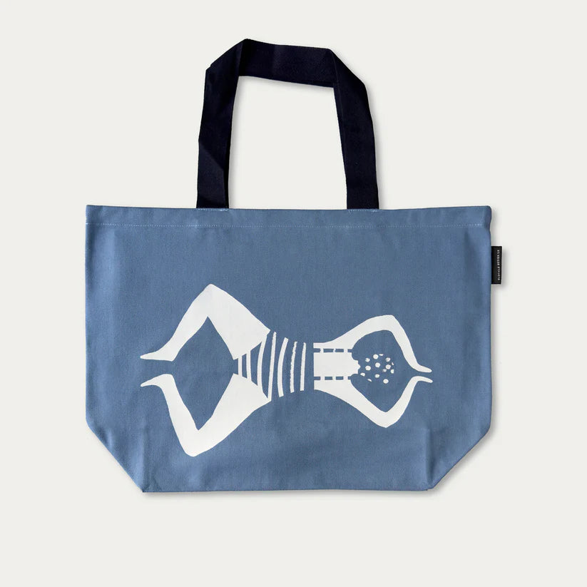 Blue tote bag featuring a white illustration of a woman in a striped swimsuit lying on her back.