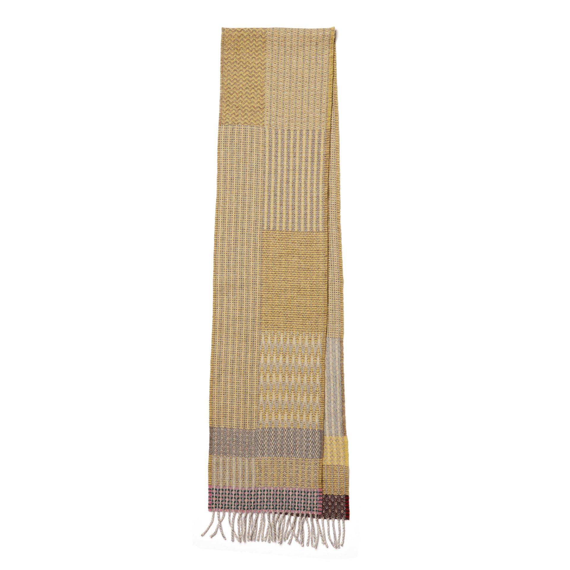 Woven scarf in muted yellow and gray tones, featuring a patchwork pattern and fringed edges.