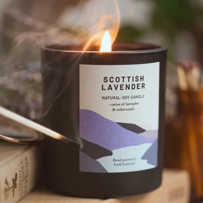 Black soy candle with a label reading "Scottish Lavender," featuring notes of lavender and cedarwood.