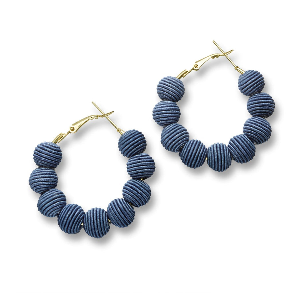 Pair of blue hoop earrings.  Each earring features gold hoops adorned with textured, spherical beads.