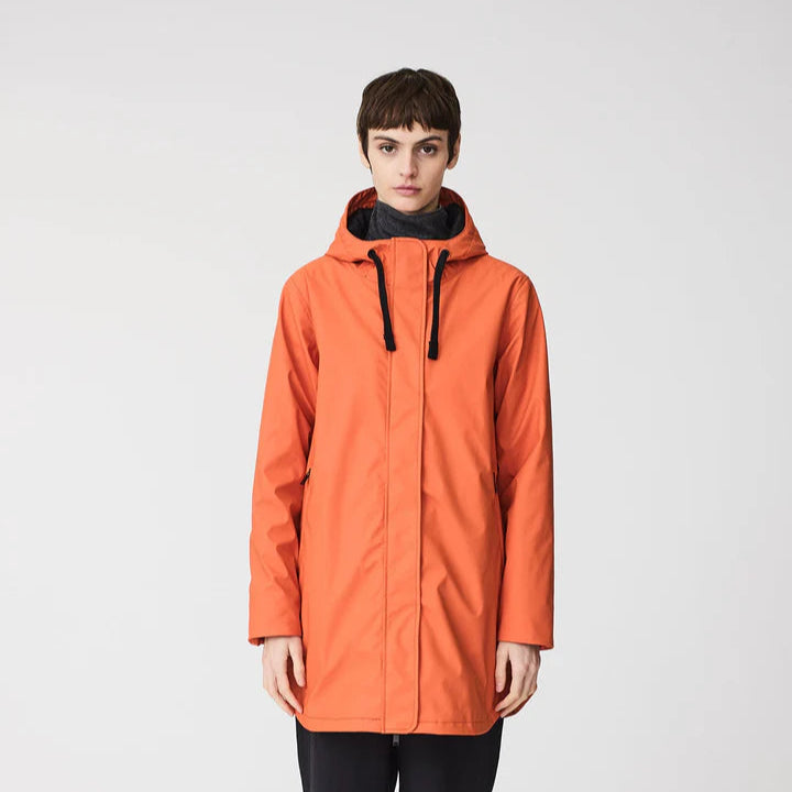 Person wearing an orange raincoat on a white background