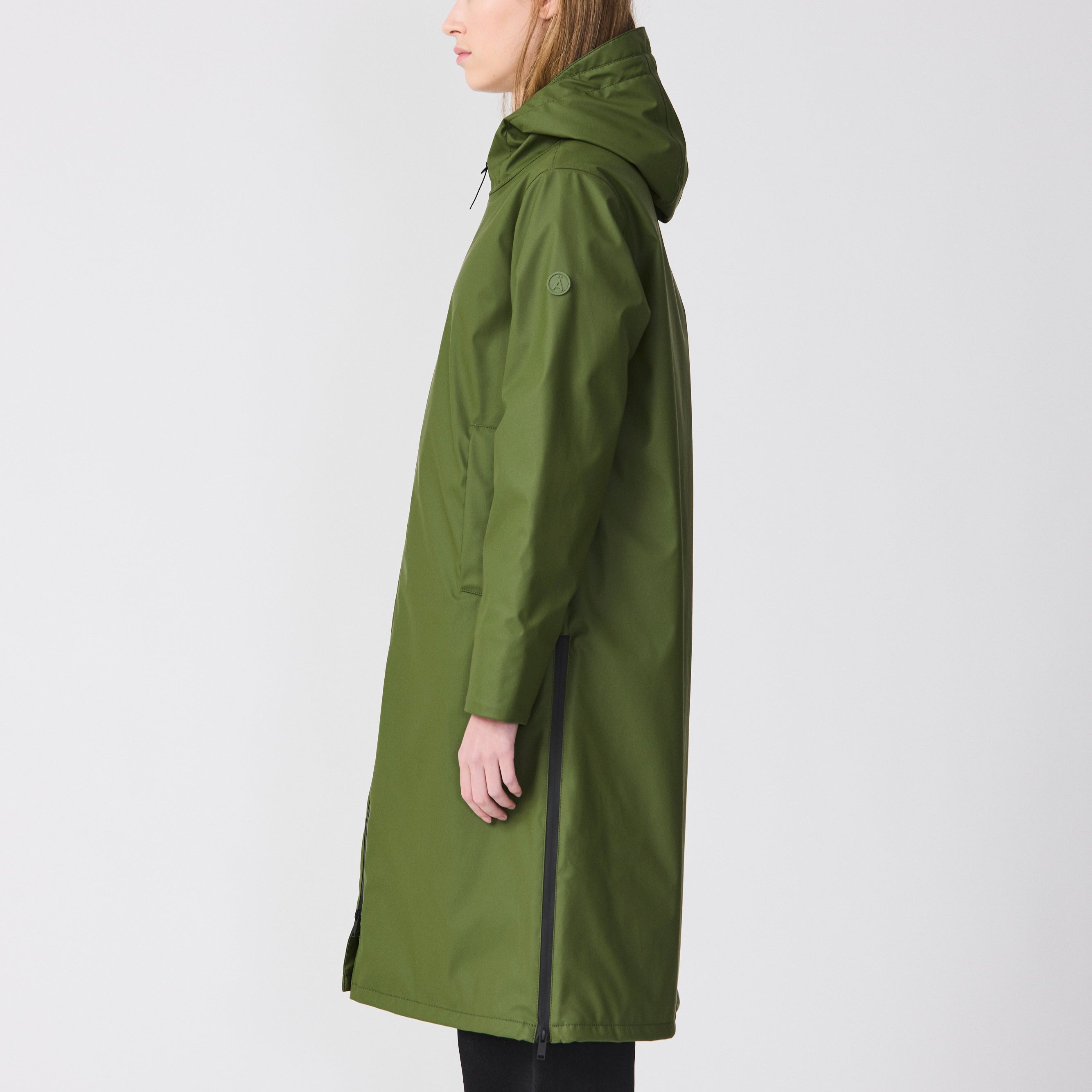 Person wearing a green raincoat on a white background