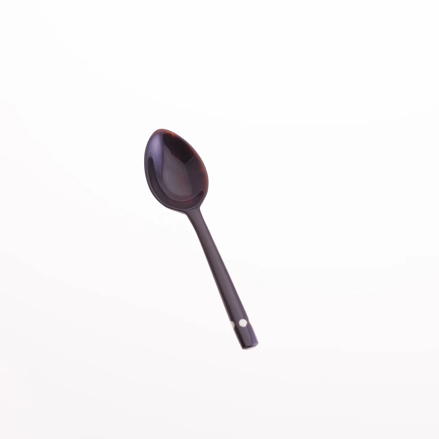 Dark brown spoon with a slightly oval bowl and a long, slender handle featuring small white dots near the end.