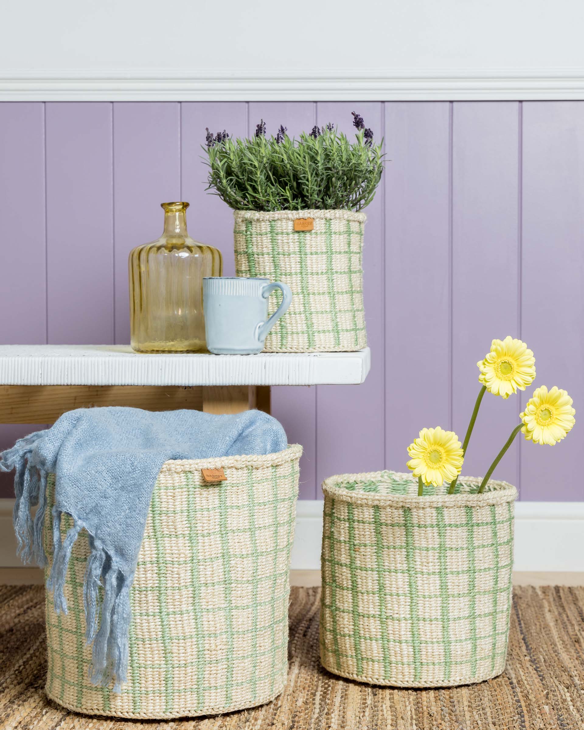 Two cream-colored woven baskets with a pale green grid pattern.