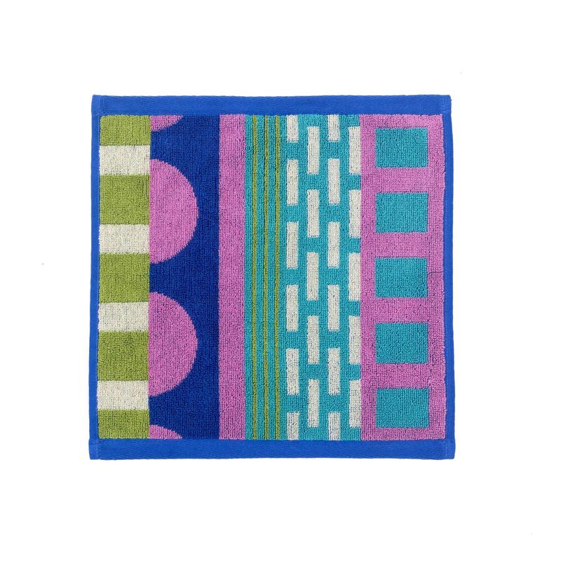 A square woven textile with a colorful geometric pattern, featuring a royal blue border and sections of pink, teal, green, and white on a white background.