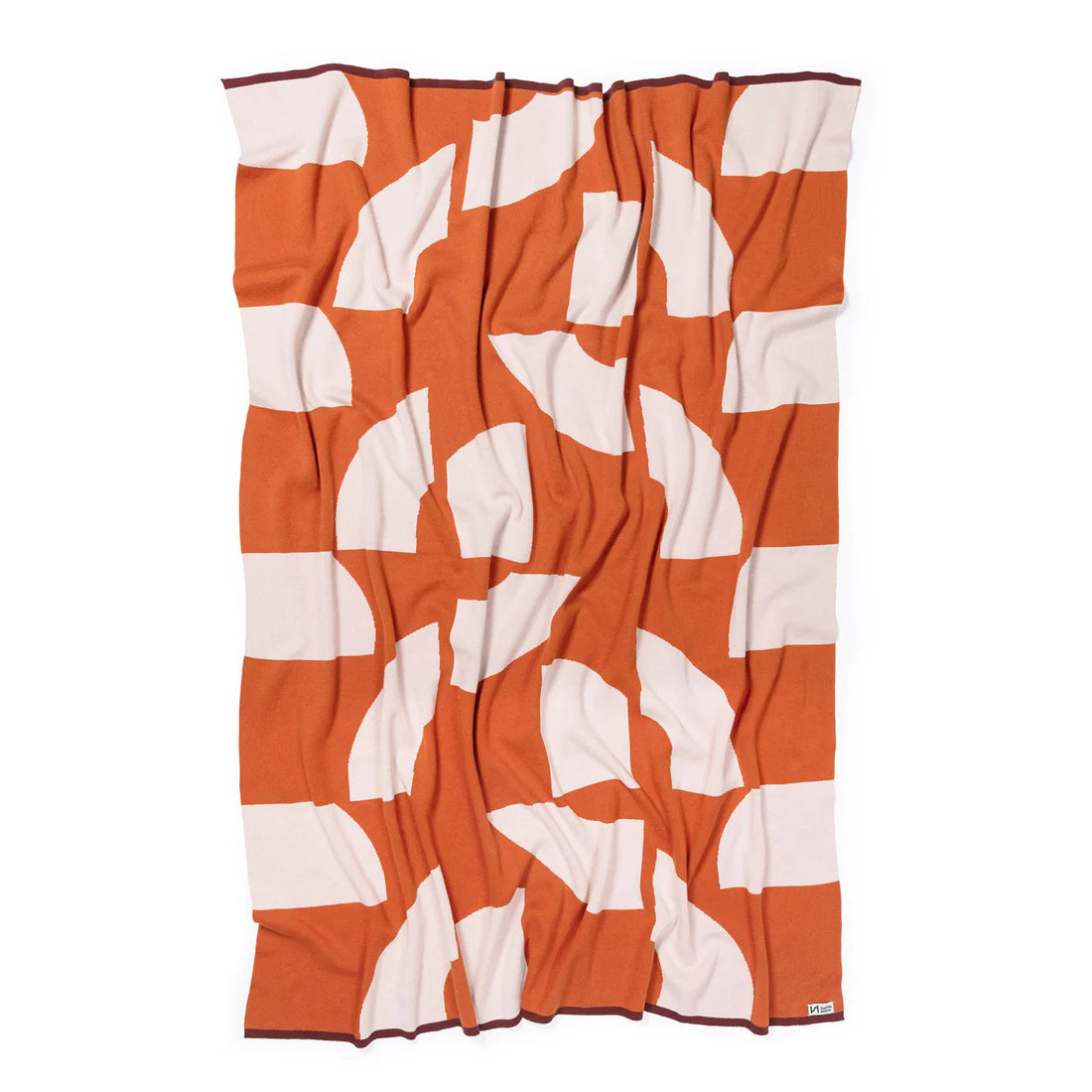 Orange and white patterned towel on a white background