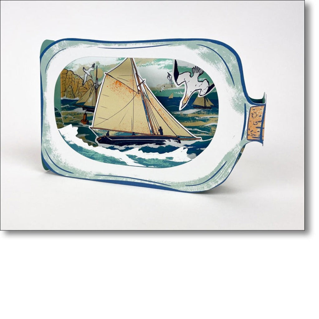 Paper-cut illustration of a sailboat inside a glass bottle, set against a seascape with seagulls.