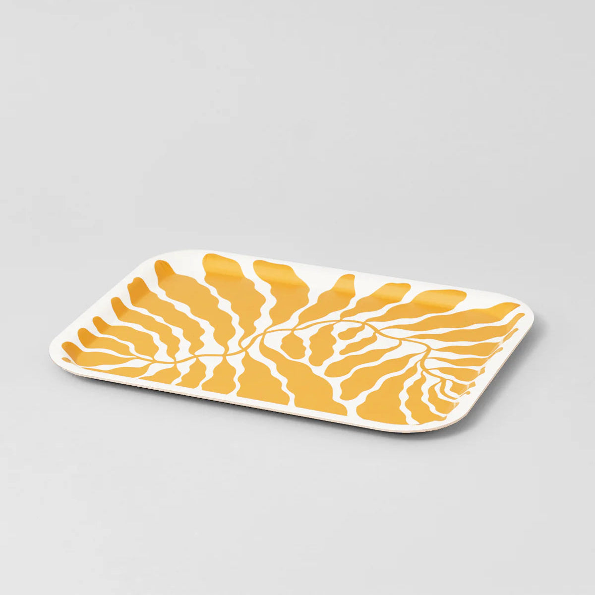 Rectangular ceramic plate with yellow leaf pattern on a gray background