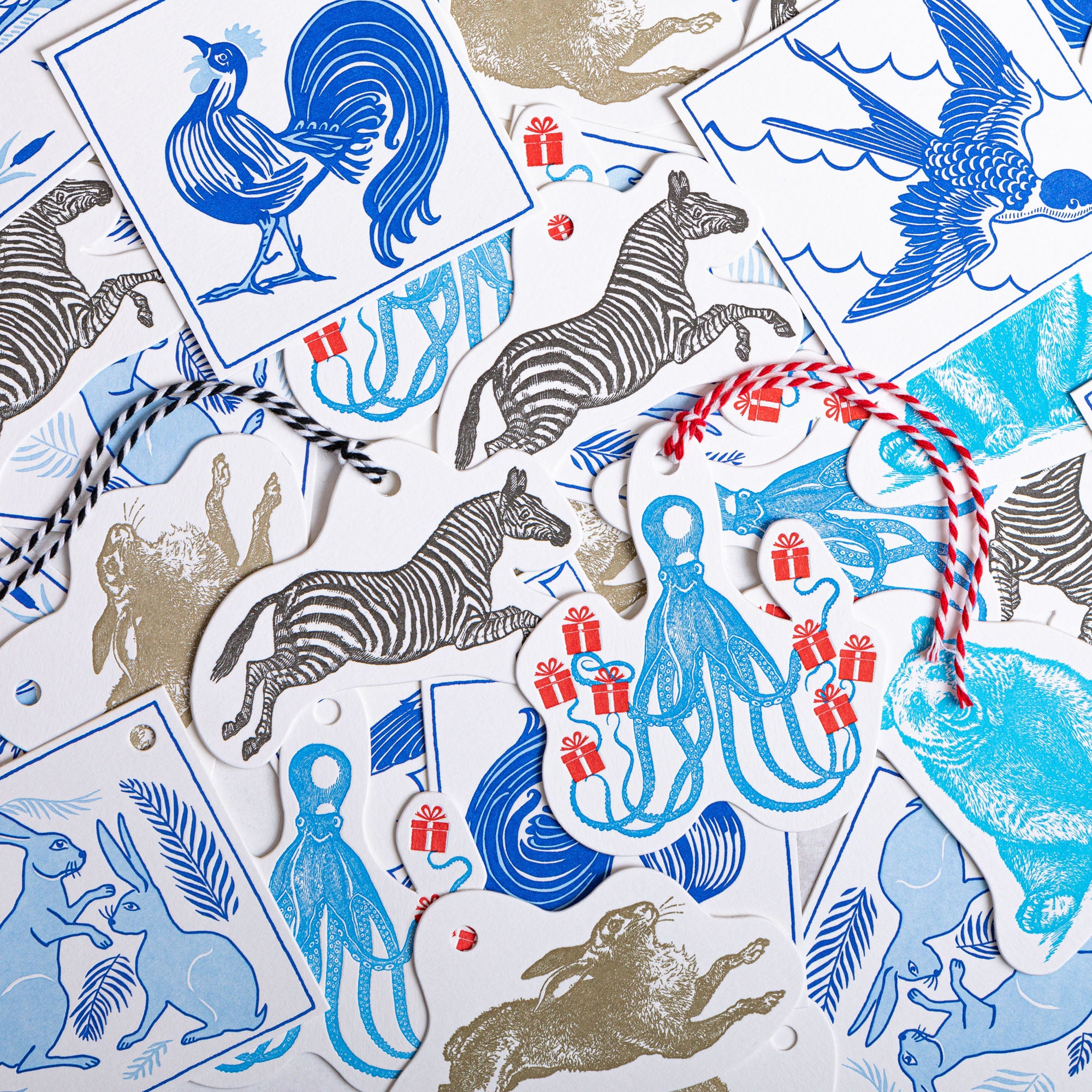 Collection of illustrated gift tags featuring various animals, including zebras, rabbits, an octopus, and a rooster, in blue