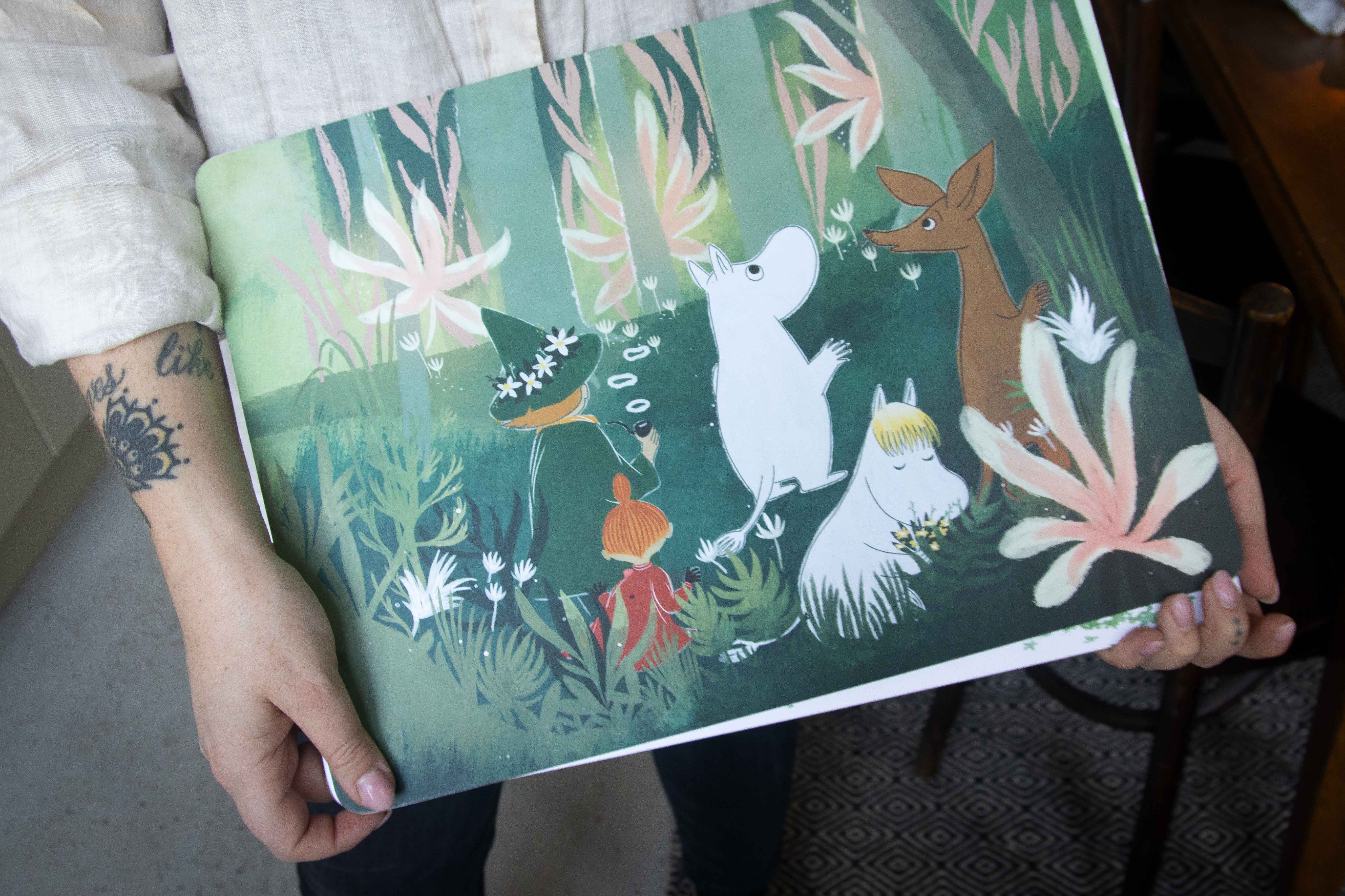 A Moomin-themed illustration print depicting Moomintroll, Sniff, the Hattifatteners, and a fox in a lush green forest
