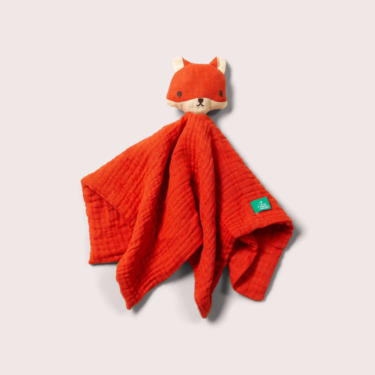 Red fox-shaped comfort blanket with a visible brand tag on a light gray background