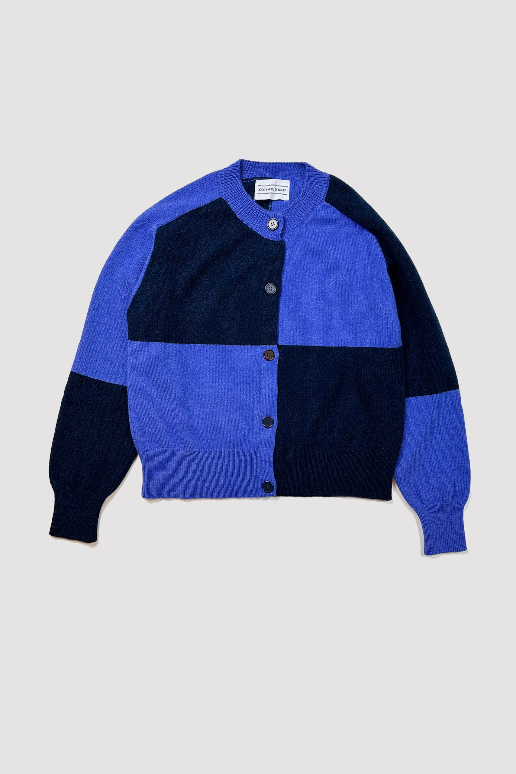 Blue and navy color-blocked wool cardigan sweater with button front closure.