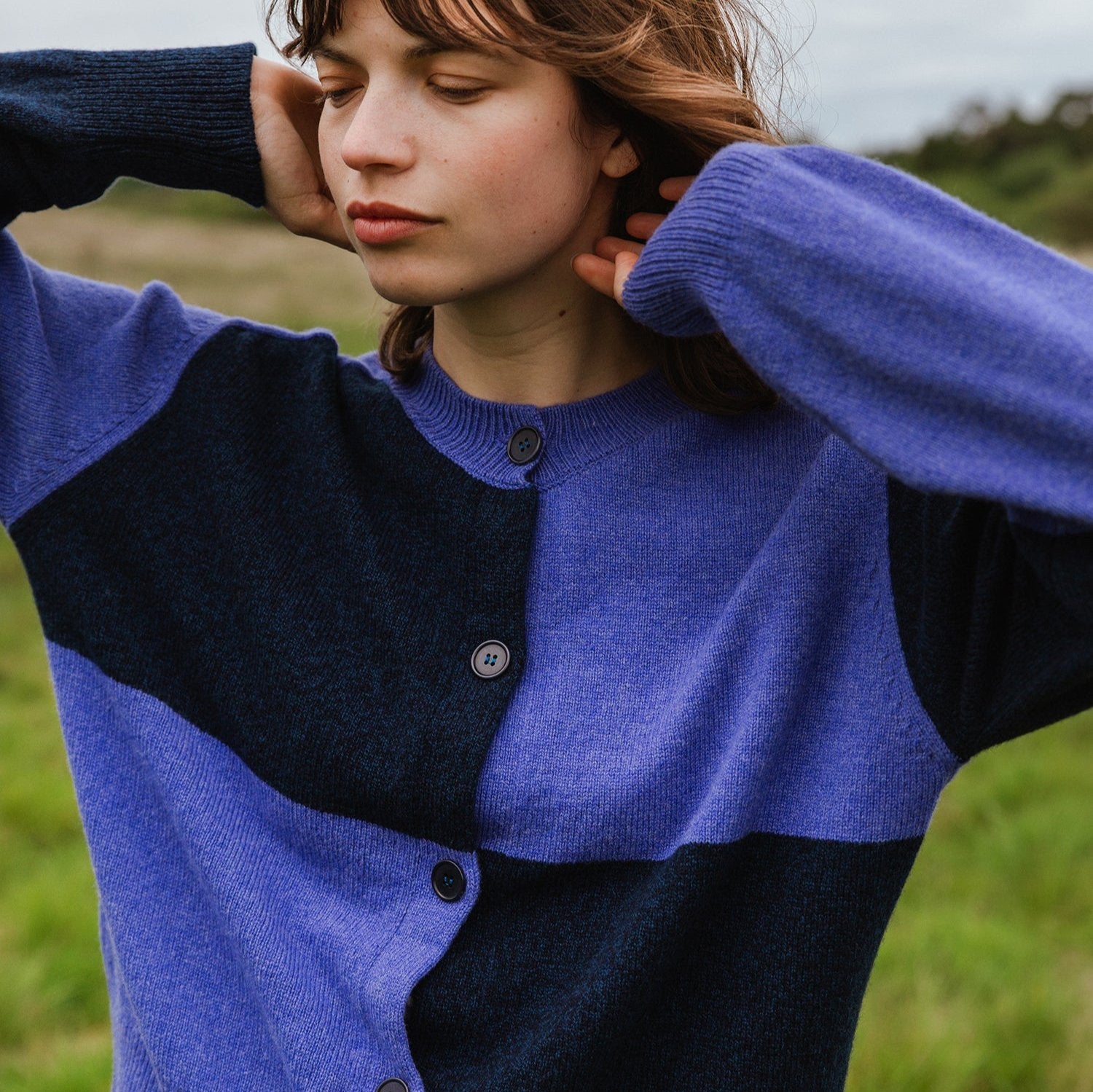 Color-blocked button-front cardigan in shades of purple and dark blue.  Soft knit fabric.