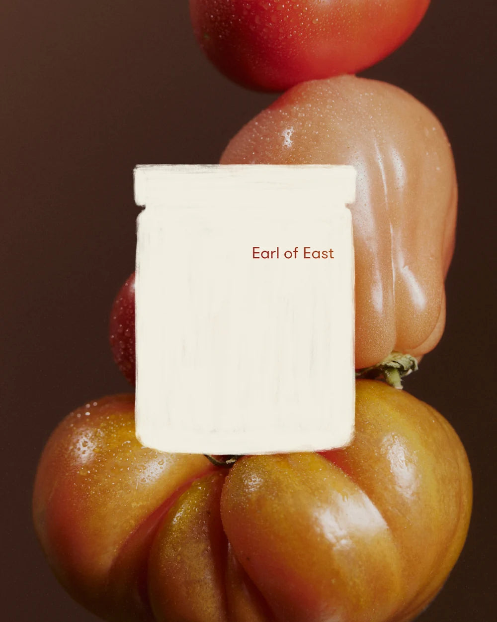 A white rectangular product block with the text 'Earl of East' printed in red, centered against a dark brown background with tomatoes around it.
