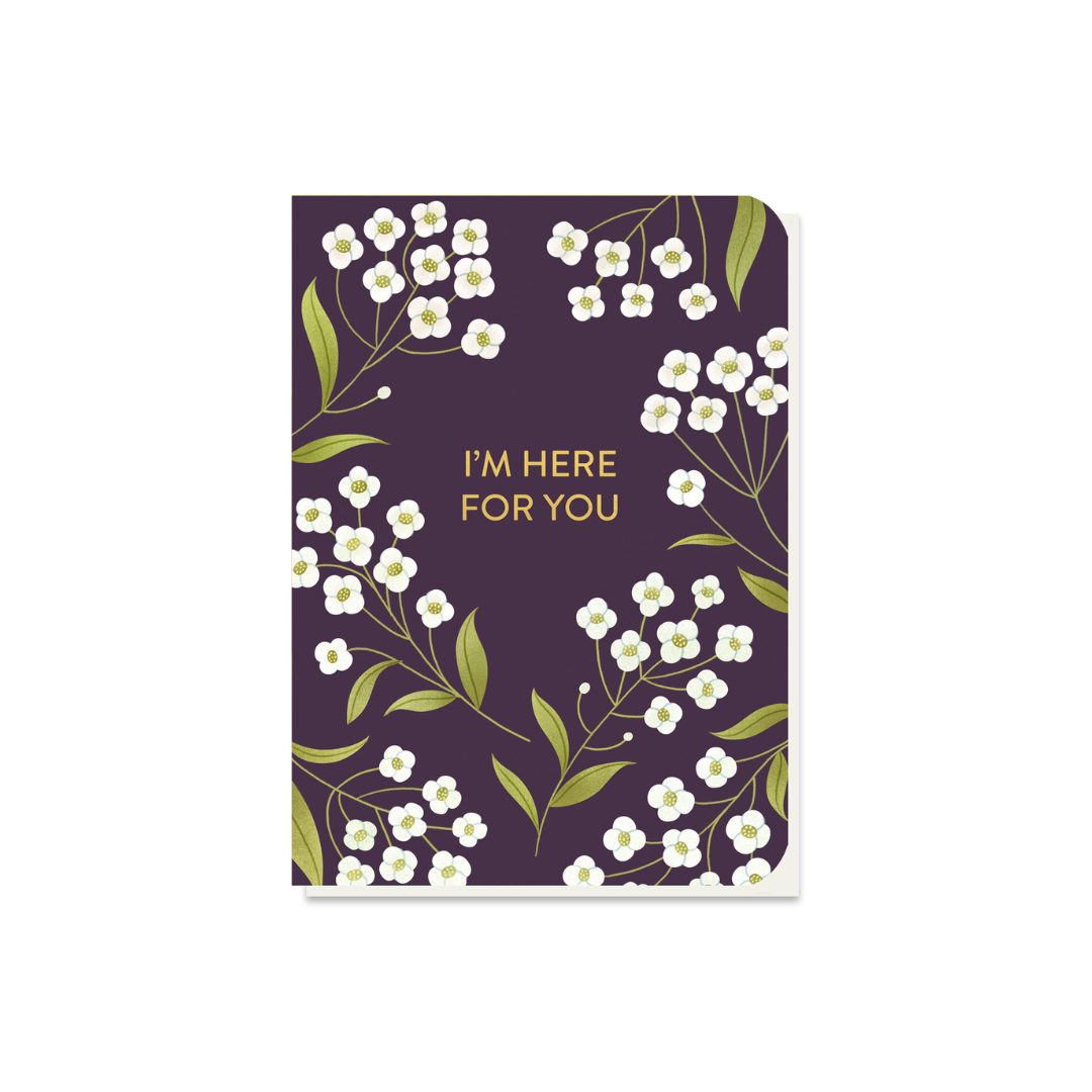 Small card with a dark purple background, featuring white flowers and gold lettering that reads "I'M HERE FOR YOU".