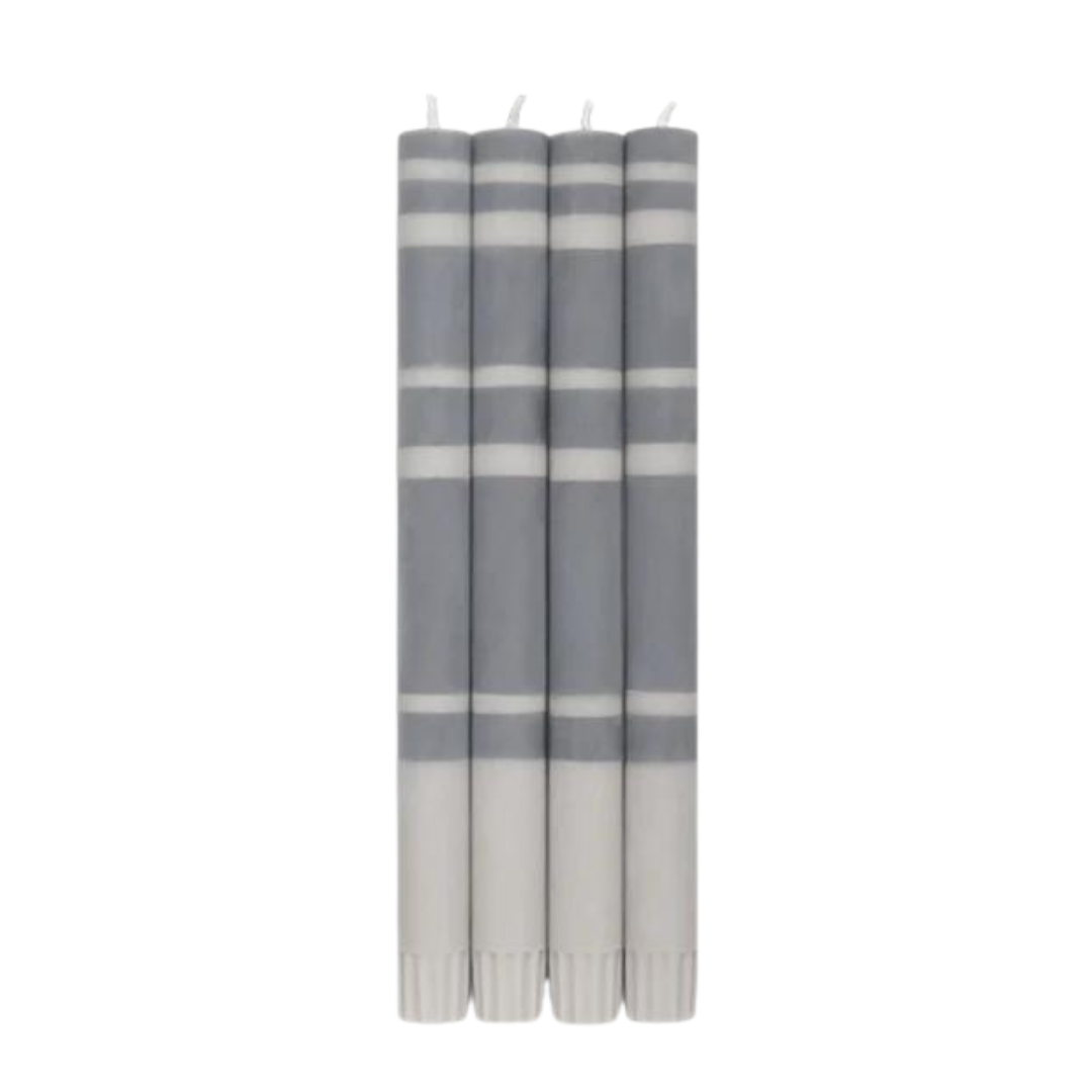 Four gray and white striped taper candles.