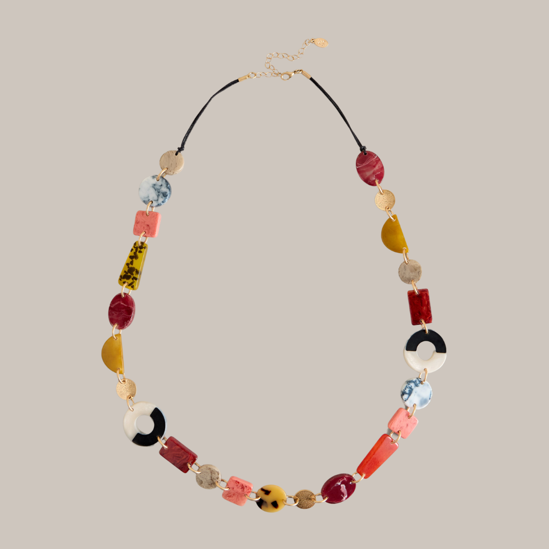 Statement necklace with multicolored resin and gold accents. Geometric shapes include circles, squares, and rectangles.