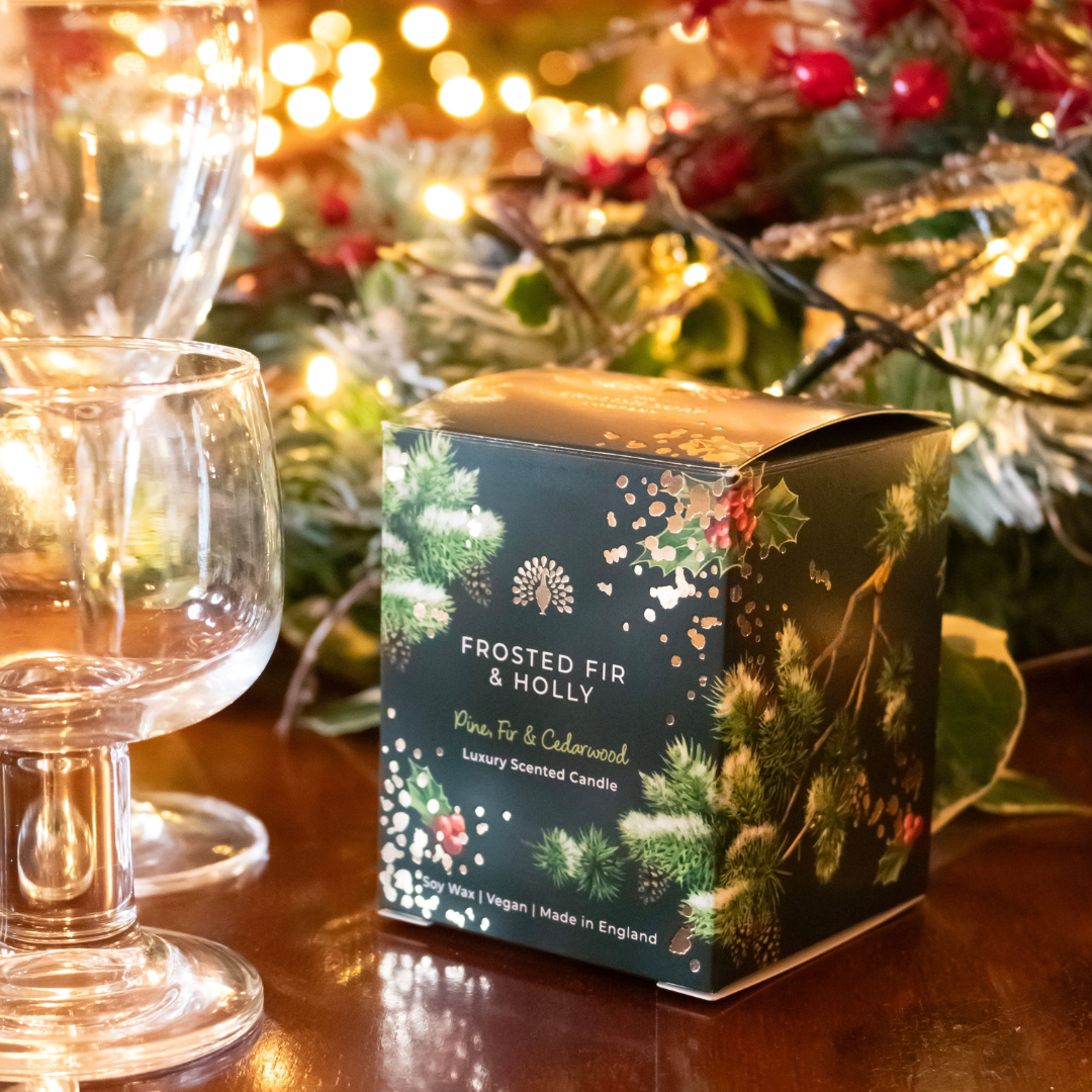 Frosted Fir & Holly luxury scented candle in a dark green box with gold foil detailing.  Pine, fir, and cedarwood fragrance.