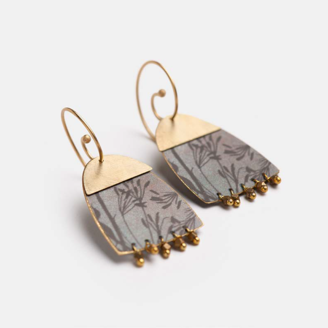 Pair of gray and gold earrings.  Arched design with floral pattern and small gold beads.