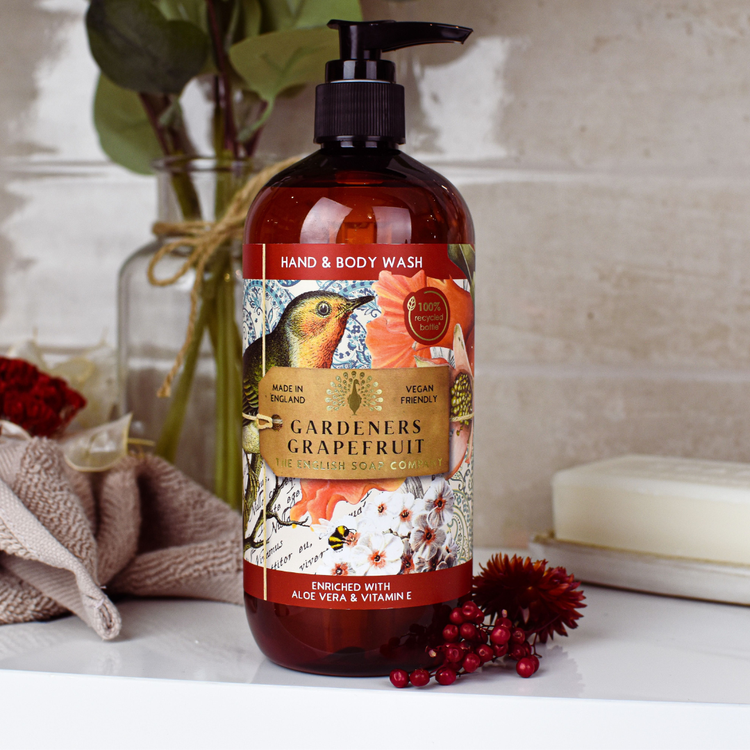 Amber bottle of Gardeners Grapefruit hand and body wash by The English Soap Company.  Features floral and bird illustration.