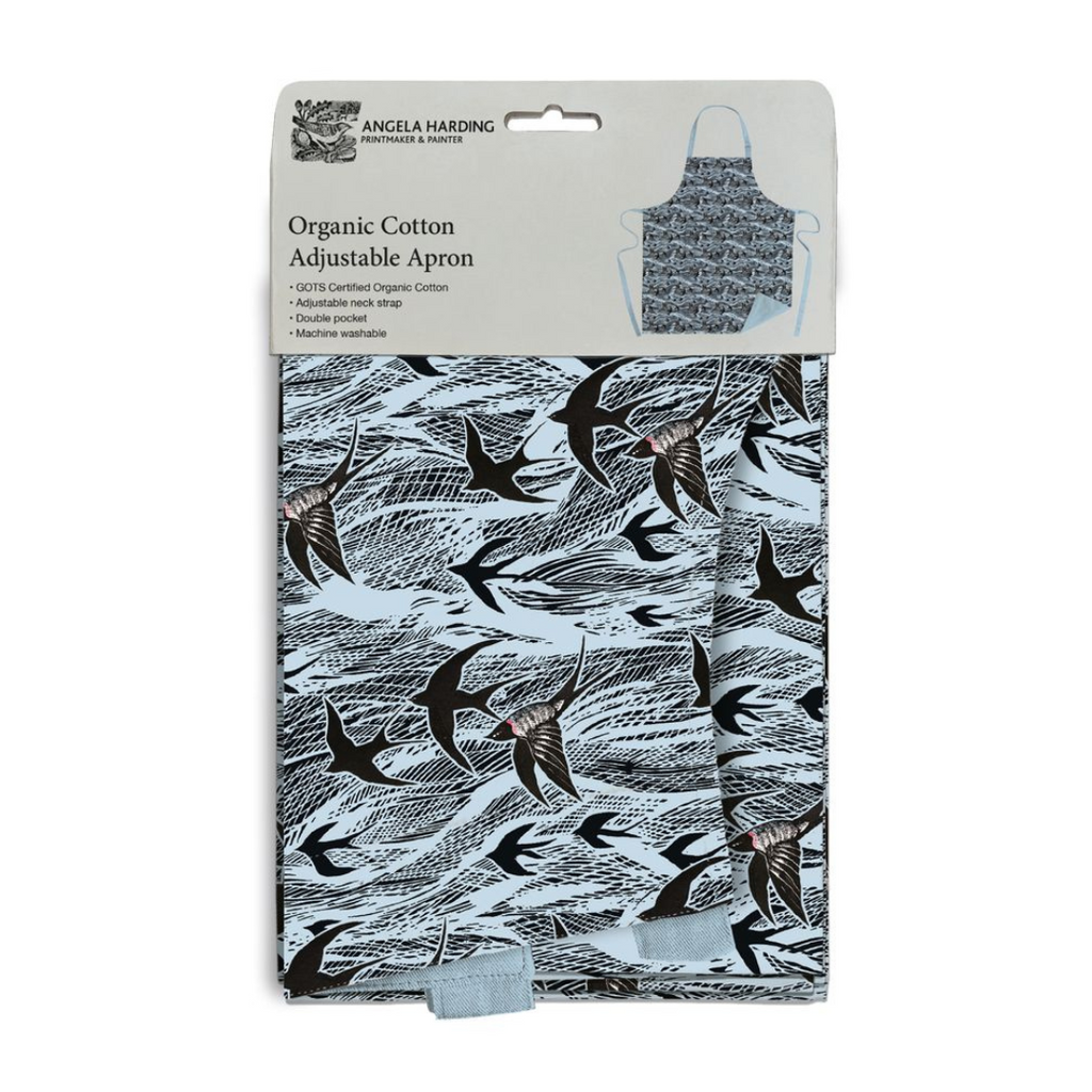Organic cotton adjustable apron with a light blue swallow print. Features adjustable neck strap and double pocket.