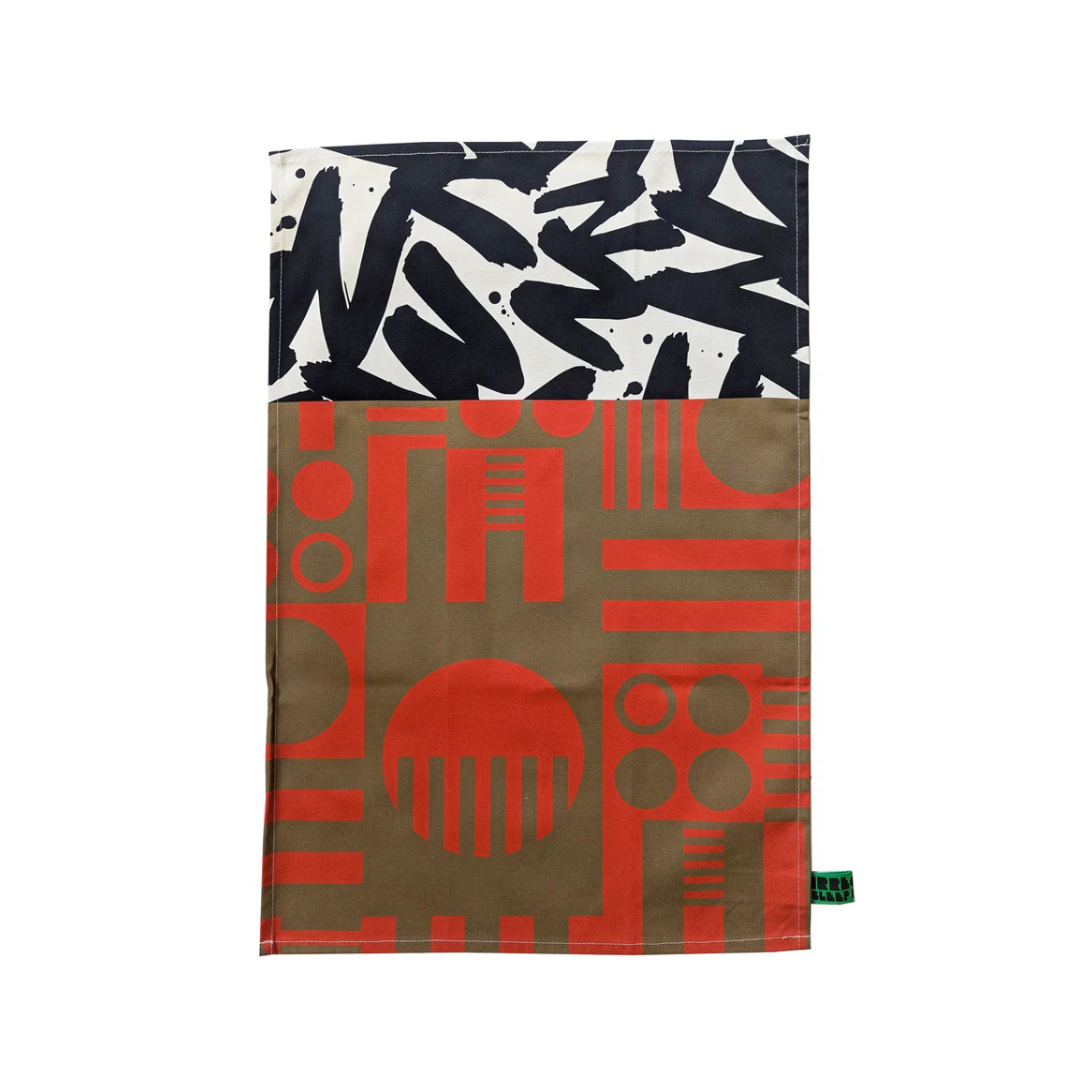 Abstract geometric patterned tea towel in orange, brown, black, and white.
