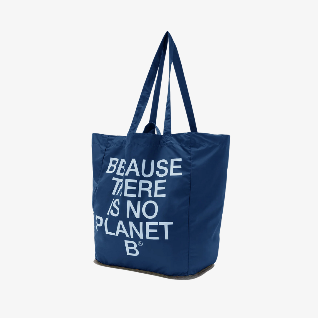 Dark blue tote bag with the text "BECAUSE THERE IS NO PLANET B" in light blue lettering.