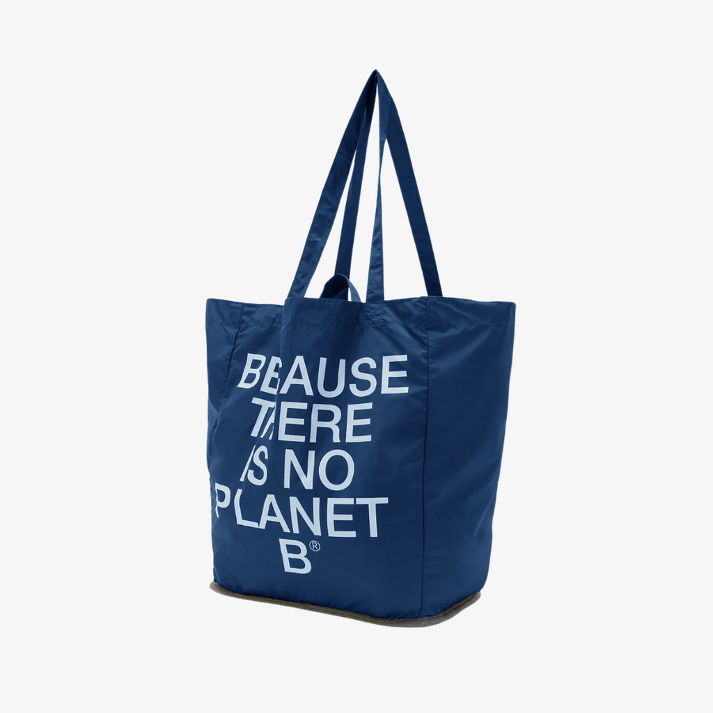 Navy tote bag from Ecoalf with white text saying "BECAUSE THERE IS NO PLANET B". Supports eco-friendly initiatives.