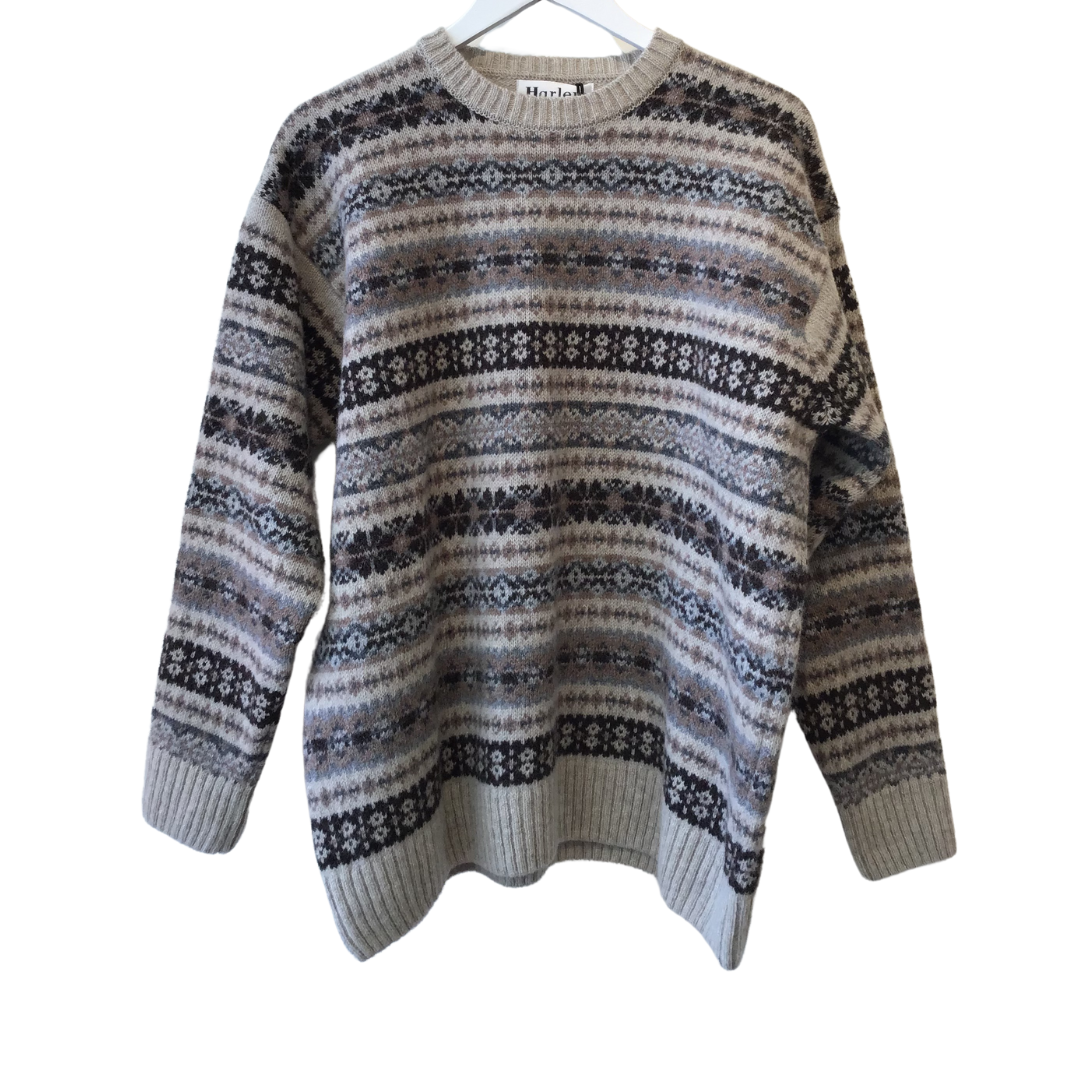 Fair isle patterned crew neck wool sweater in beige, brown, and gray.