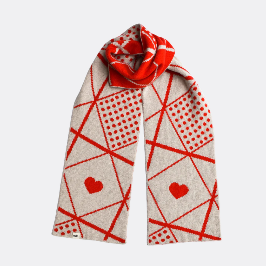 Beige and red patterned knit scarf with hearts and polka dots.