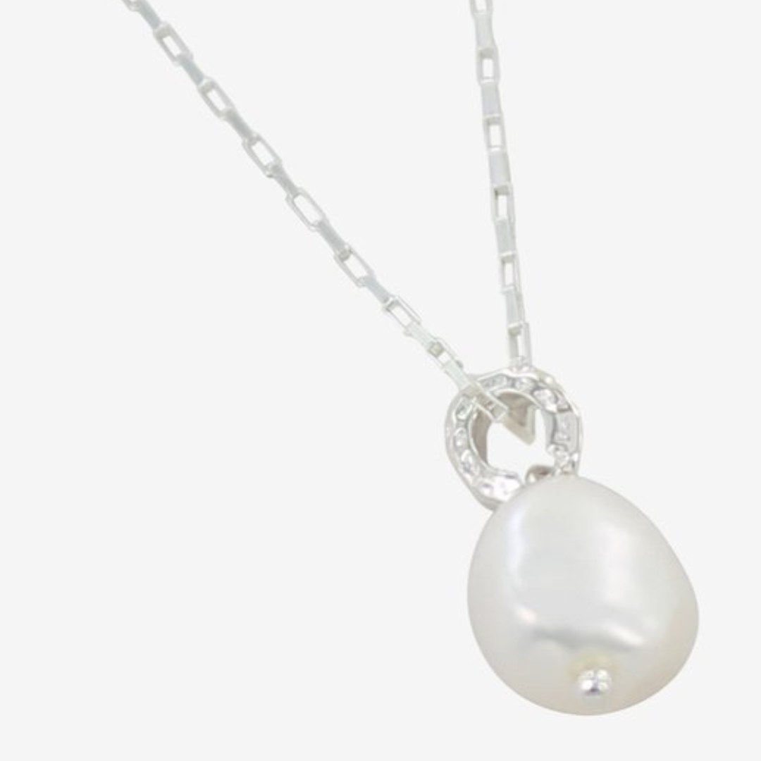 Silver necklace with a teardrop-shaped pearl pendant and a small, sparkly, circular accent.
