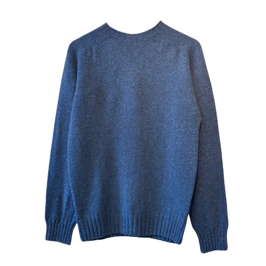Blue speckled knit sweater, long sleeves, ribbed cuffs and hem, shown from the back.
