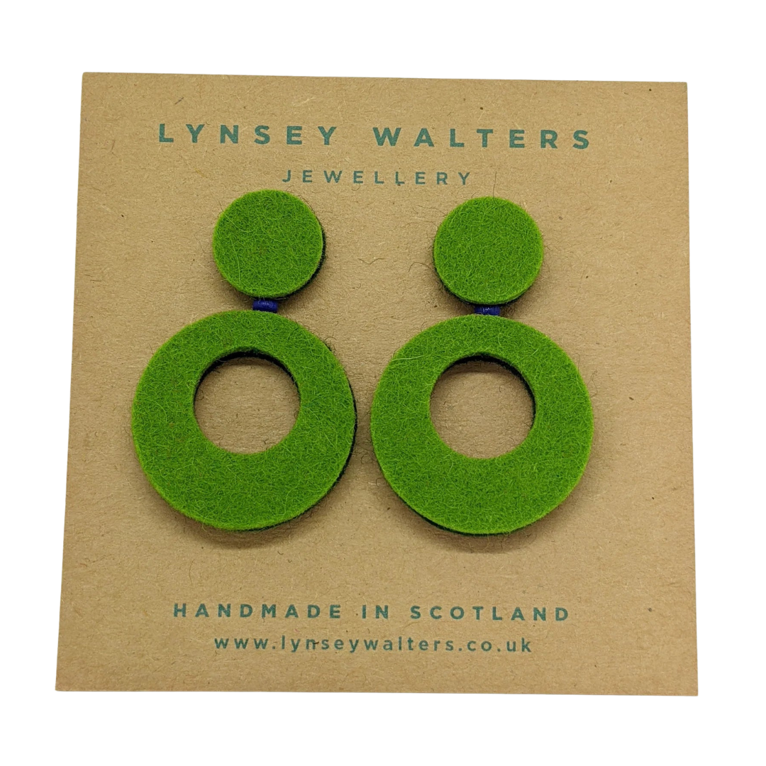 Green circular earrings on a Lynsey Walters branded card.