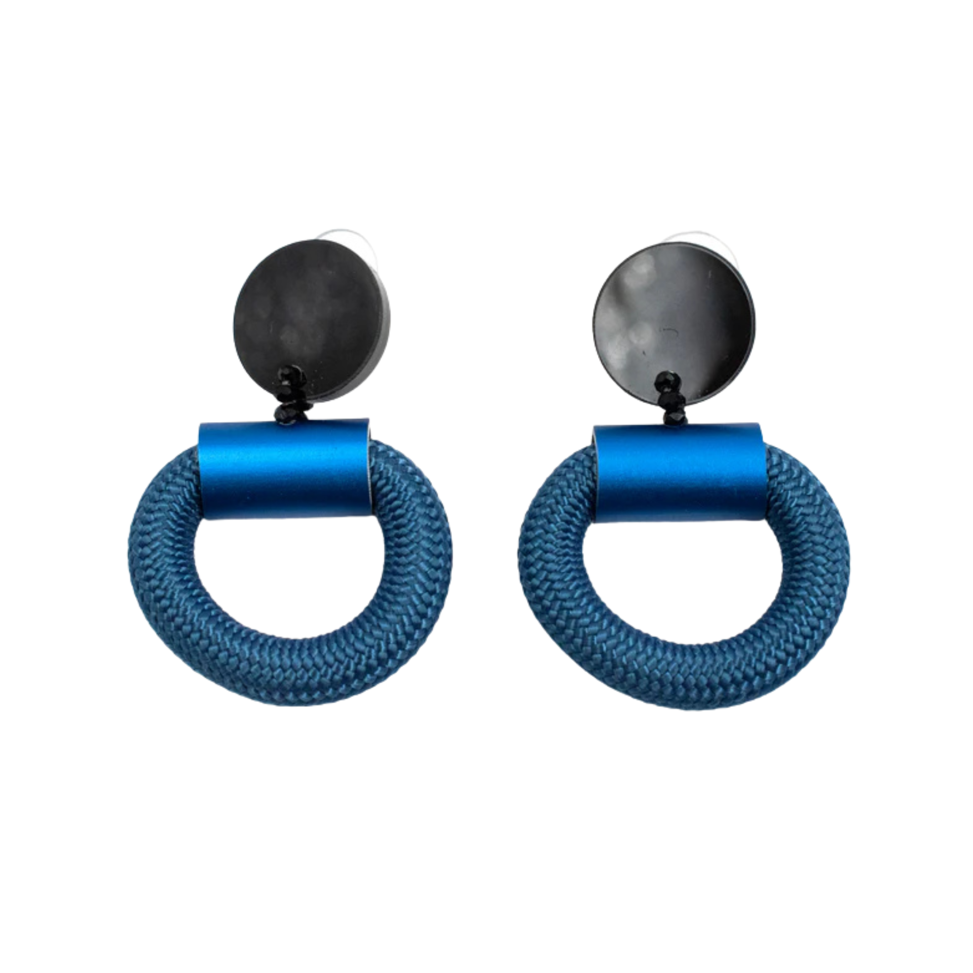 A pair of blue statement earrings featuring a thick, braided circular ring suspended from a matte black cylindrical connector and a round disc, shown on a plain white background.