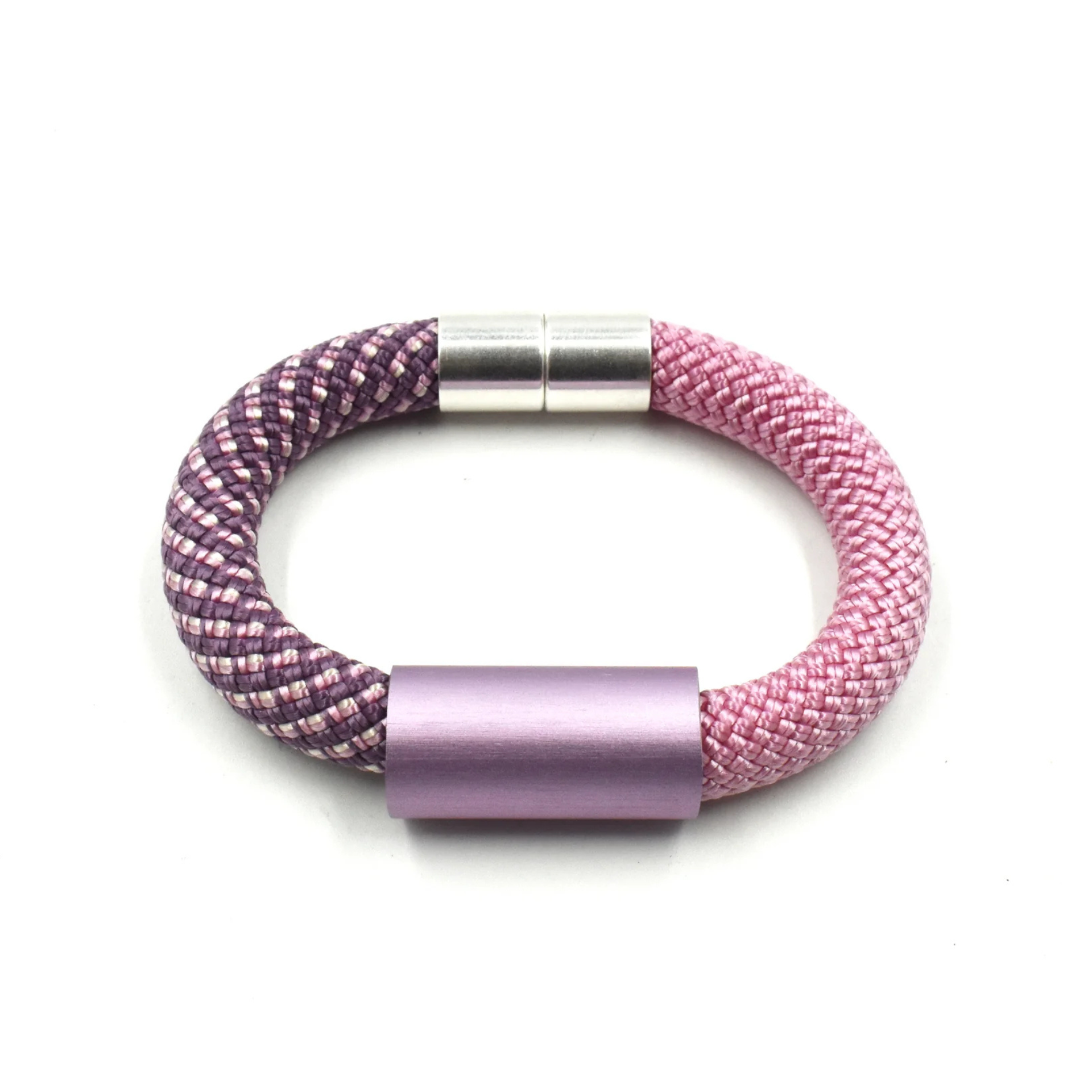 A braided bracelet with a split purple and pink design, featuring a silver cylindrical clasp and a lavender metallic center cap, shown on a plain white background.