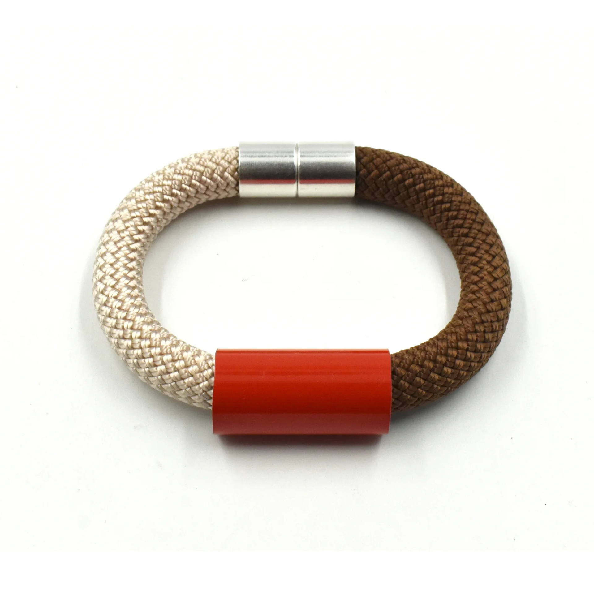 A braided cord bracelet with a beige off-white section, a brown section, a bright red cylindrical accent, and a silver metal clasp, shown on a plain white background.