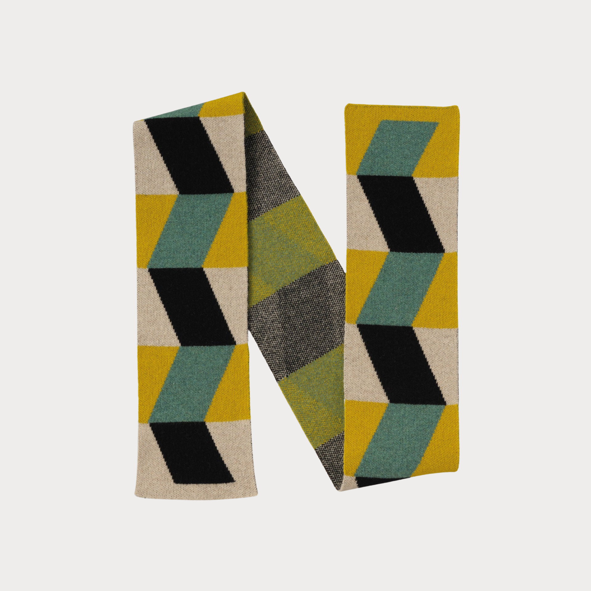 A geometric-patterned scarve in green, teal, yellow, and black on a light gray background