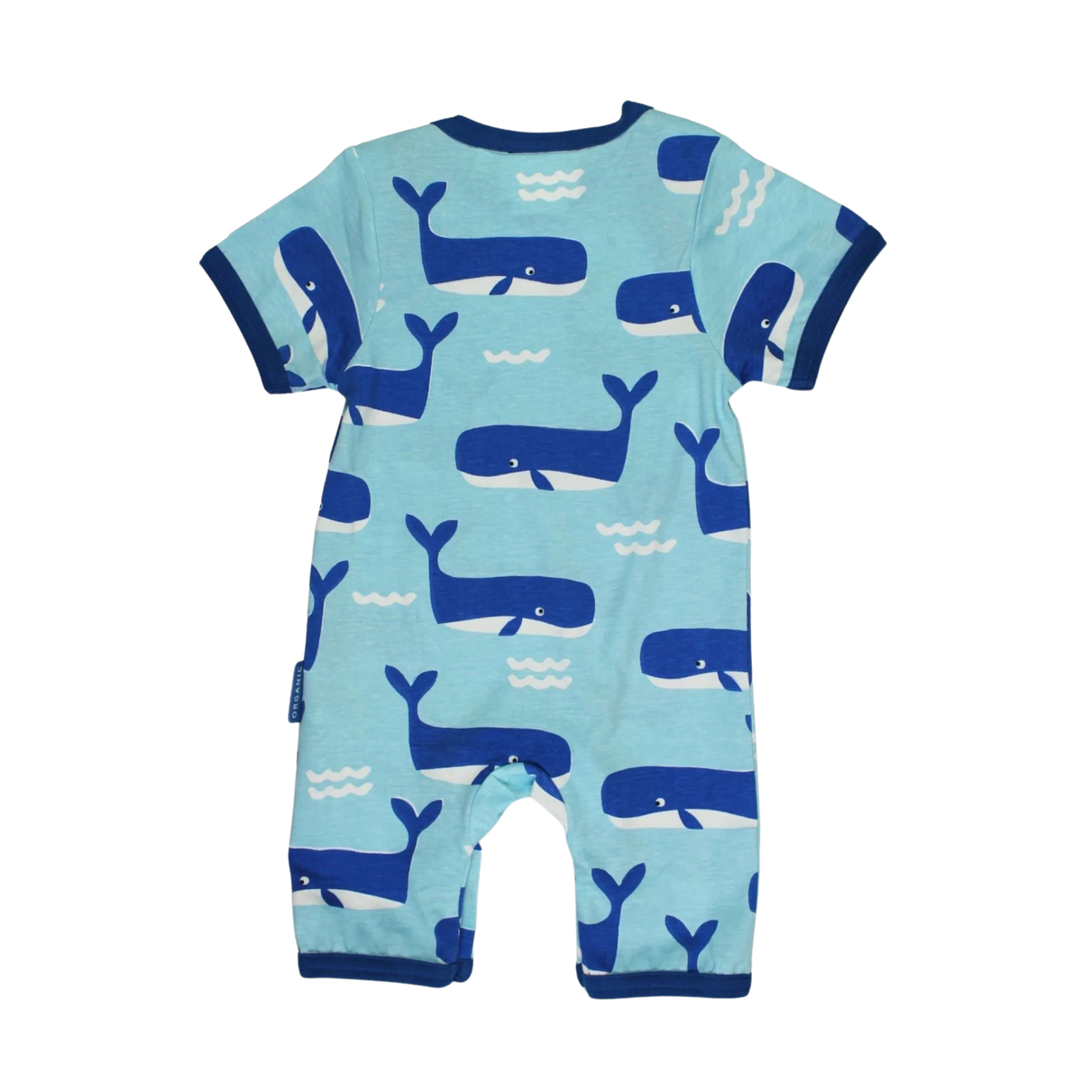 A baby short-sleeve romper in light blue with a playful pattern of dark blue whales and small white waves, featuring dark blue trim on the collar, sleeves, and leg cuffs.