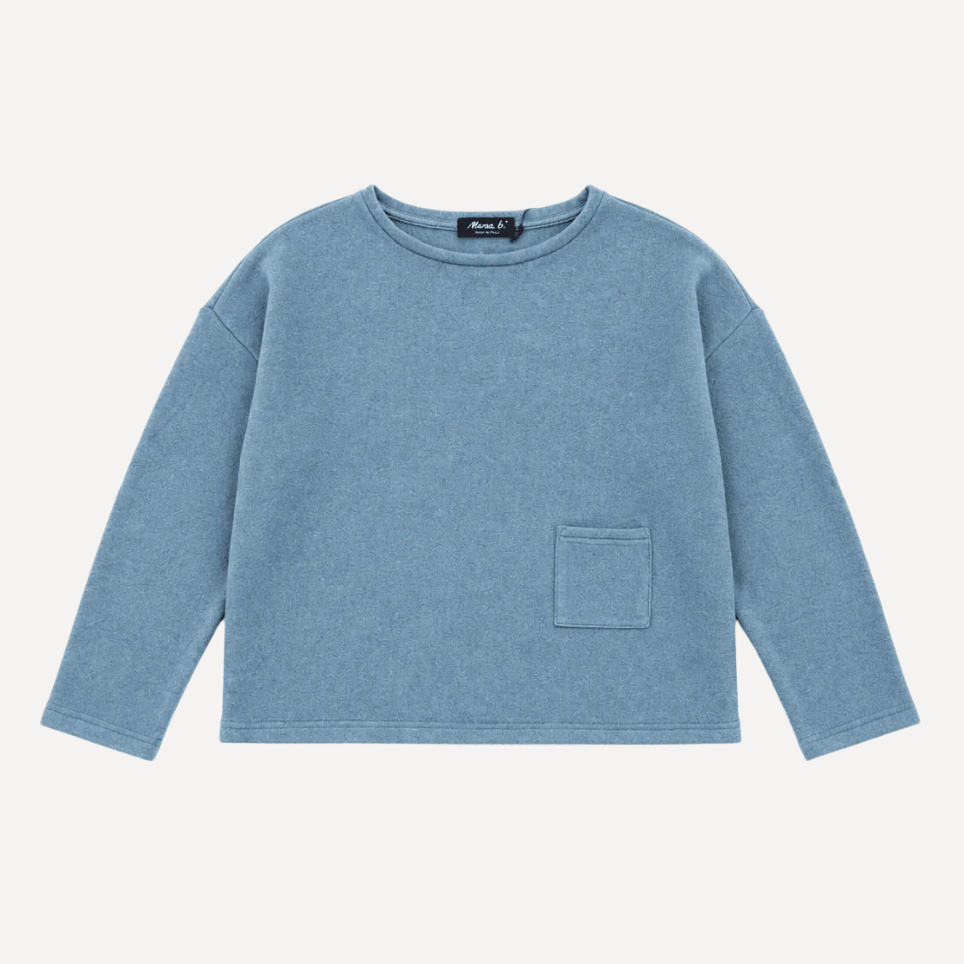 A light blue long-sleeve crewneck sweatshirt with a single front patch pocket, laid flat against a light off-white background.