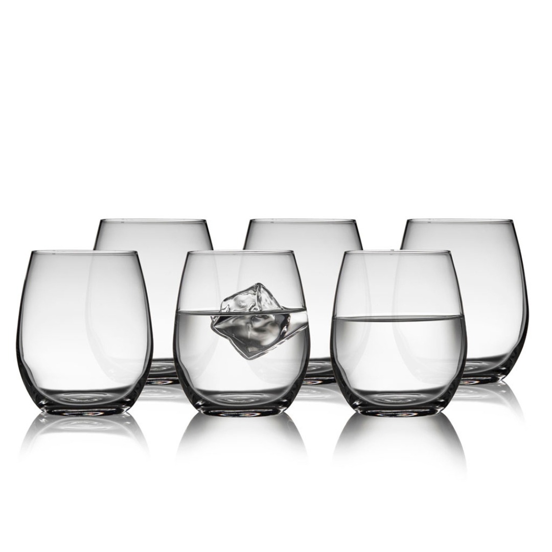 Set of six clear stemless wine glasses; some filled with water and ice.