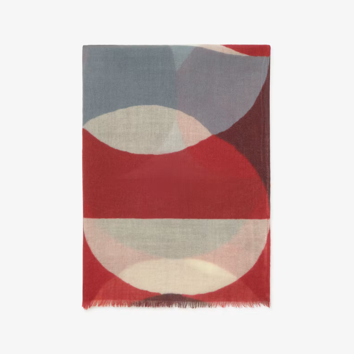 A rectangular scarf with abstract geometric patterns in red, slate blue, cream, and burgundy, featuring fringed edges, shown flat against a light gray background.